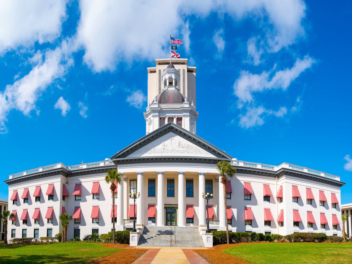Historic Florida State Capitol Building with brightly colored striped awnings and classical dome