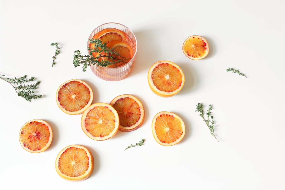 Fresh Blood Orange Cocktail with Thyme and Citrus slices, a refreshing non-alcoholic botanical drink